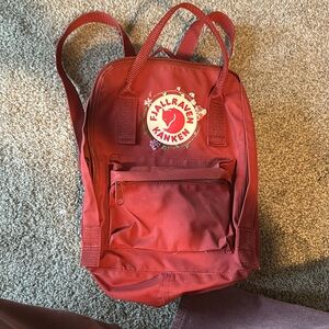 Mini red fjallraven backpack. I embroidered it myself :)